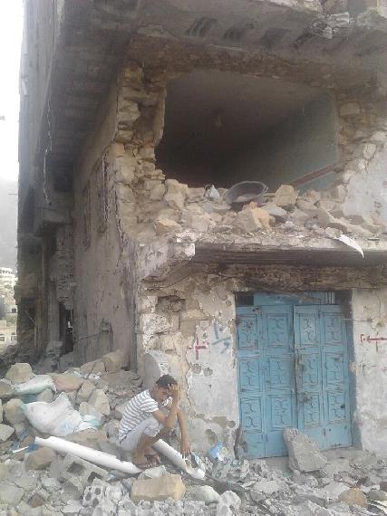 Ahmad weeping in front of his home in Taiz left uninhabitable by shelling